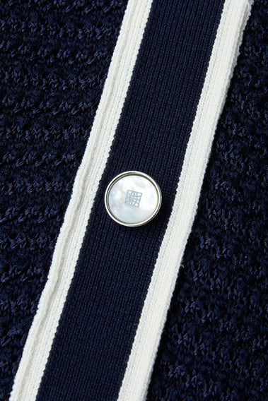 ELEGANT NAVY POLO FEATURING WHITE TRIM DETAILS, A TIMELESS WARDROBE STAPLE